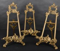 20th Century English School. A Set of Three Brass Picture Stands, height 22.5