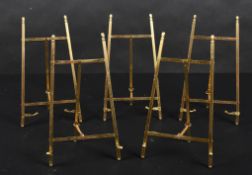 20th Century English School. A Set of Five Brass Picture Stands, height 10