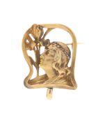Broche Art Nouveau or 585 ajouré figurant un profil féminin la tête ceinturée d'un bandeau serti de
