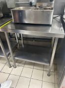 Stainless steel table with back splash and under shelf 80cm x 65cm x 83cm Note this lot has a lift
