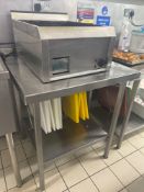 Stainless steel table with back splash and under shelf 74cm x 46cm x 86cm Note this lot has a lift