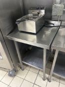 Stainless steel table with back splash and under shelf 60cm x 65cm x 85cm Note this lot has a lift