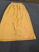 A Pair Lined Pencil Pleat Top Of Fabric Drapes Matte, Textured Fabric In A Warm, Solid Gold Or