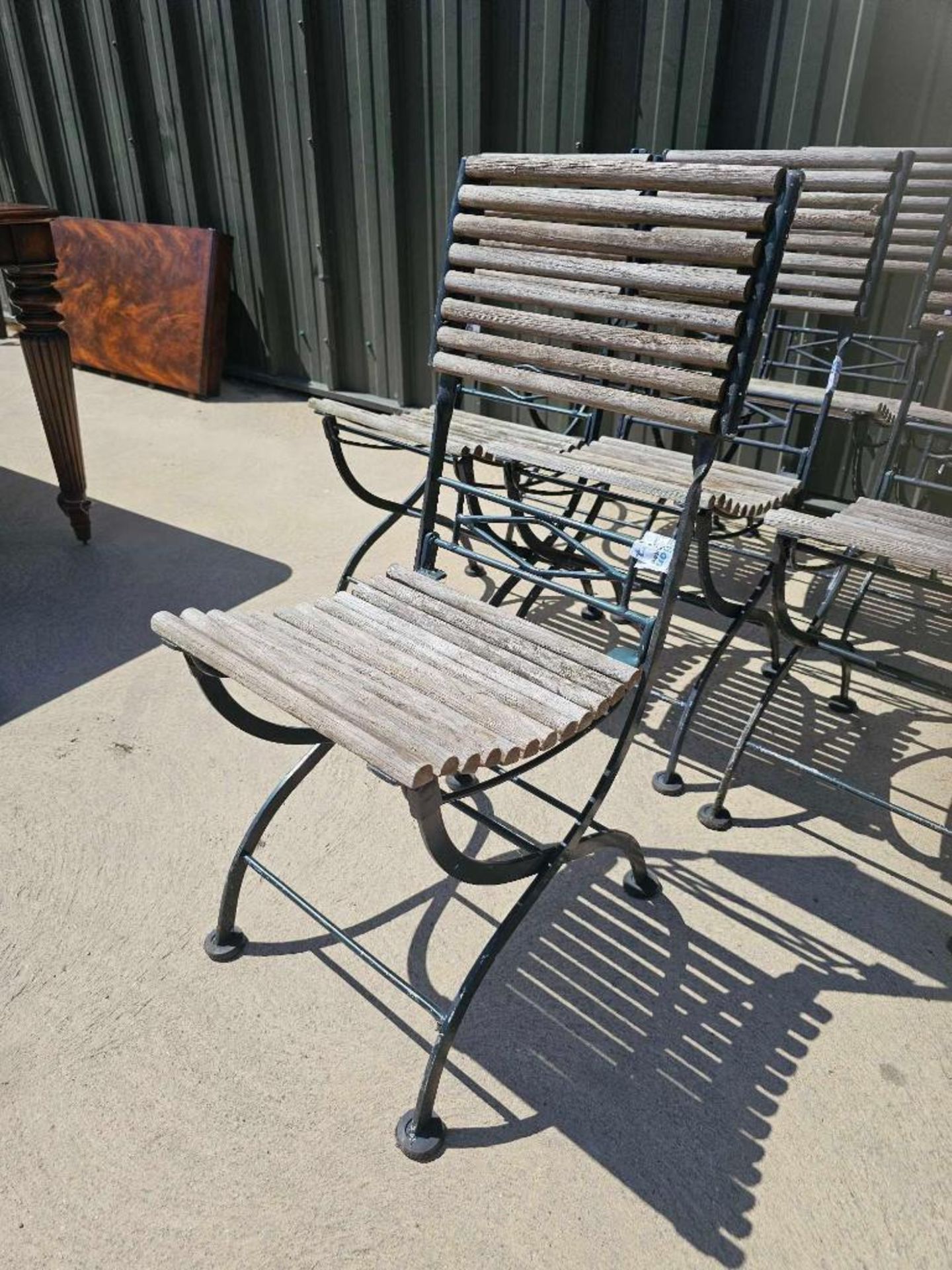 A set of seven vintage French folding bistro chairs features a weathered, rustic aesthetic - Image 3 of 5