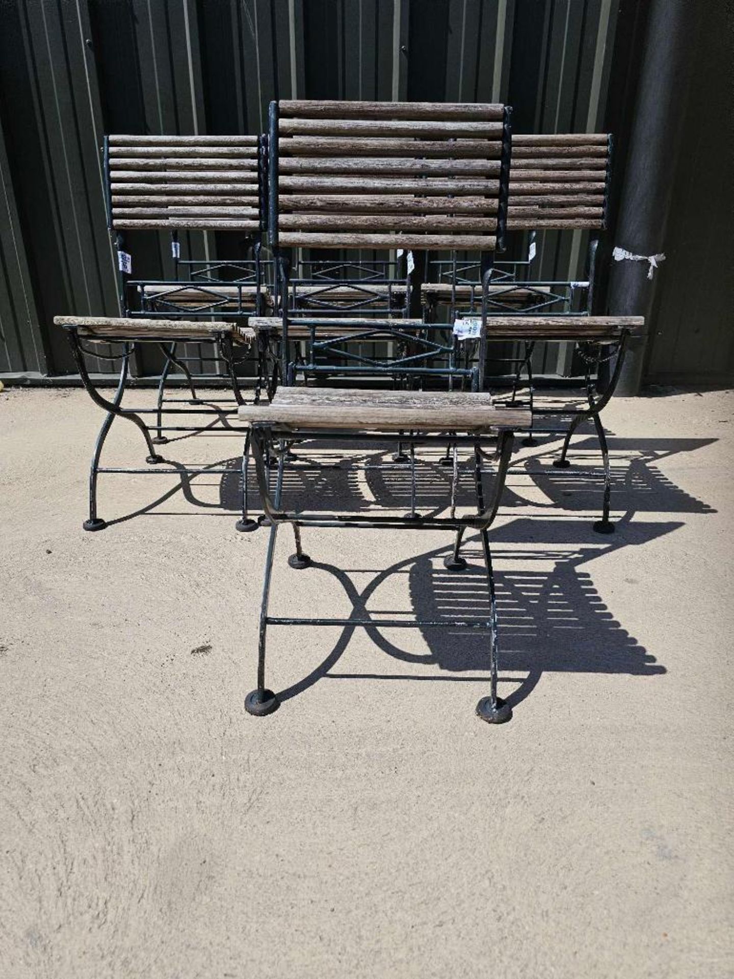 A set of seven vintage French folding bistro chairs features a weathered, rustic aesthetic - Image 4 of 5