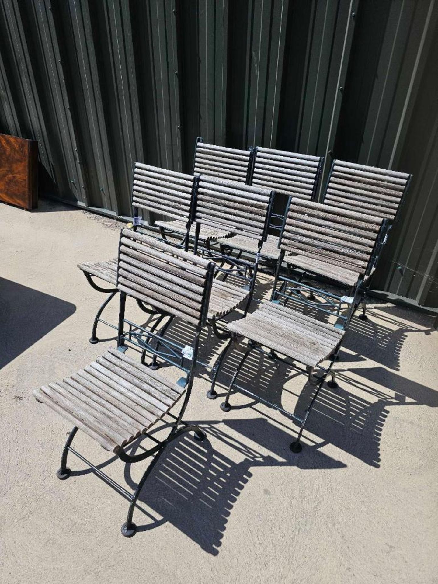 A set of seven vintage French folding bistro chairs features a weathered, rustic aesthetic - Image 2 of 5