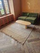 A sophisticated contemporary lounge ensemble featuring a pair of Eave Modular Seats in a rich moss