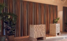 A set of fully lined drapes features a sophisticated vertical stripe pattern in alternating tones of