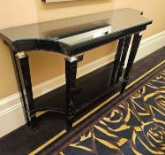 A sculptural black‑gloss console table by Francesco Molon, Italy, defined by its crisp architectural