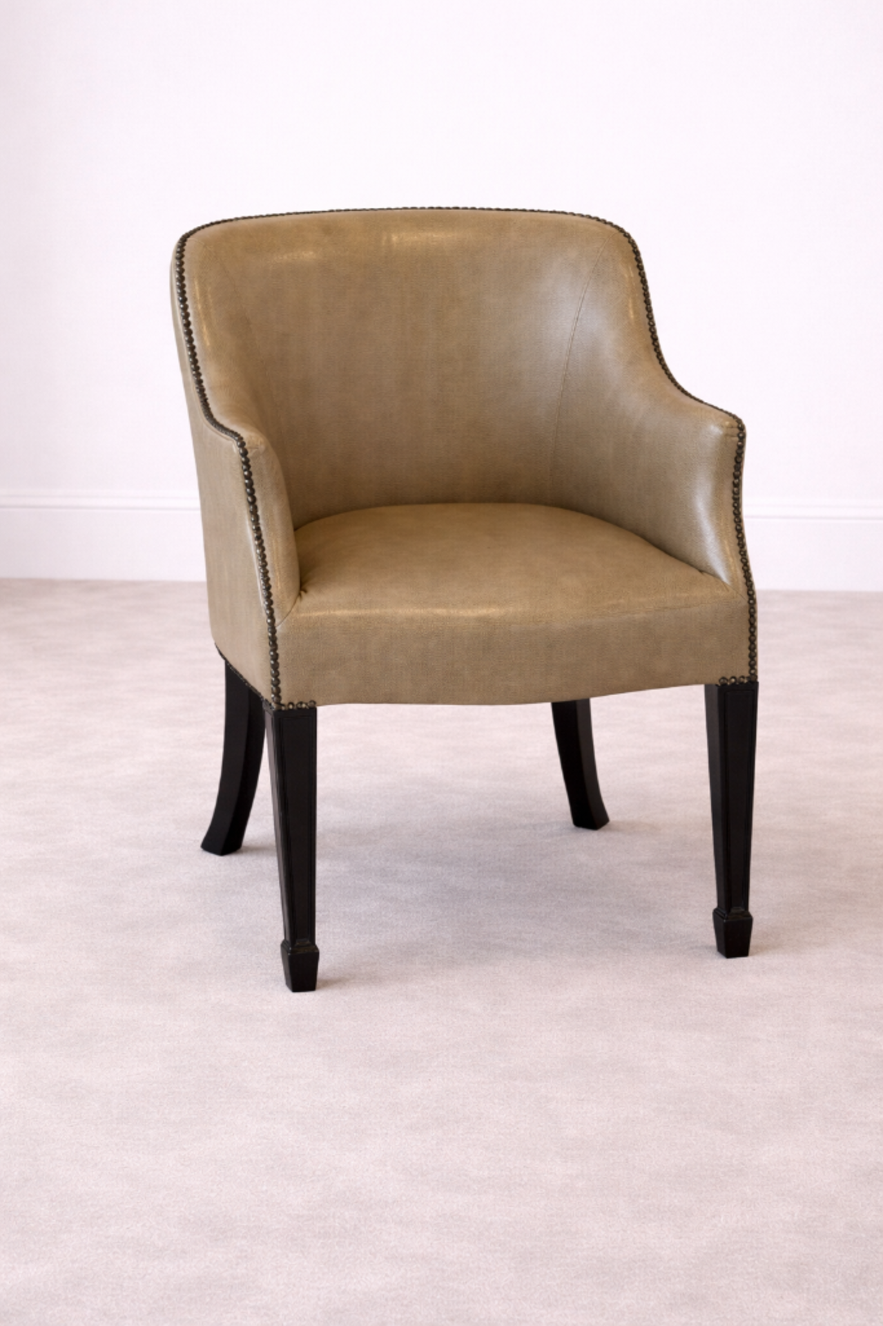 Whittemore Sherrill Style Barrel-Back Leather Armchair This barrel-back armchair, in the style of