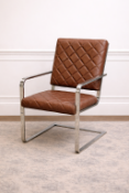 An OKA cantilever armchair featuring a polished chrome frame and distinctive tan-coloured faux