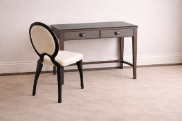 An Italian-made writing desk and coordinating chair set. The desk features two soft-close drawers