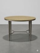 An ovoid-form coffee table featuring a bronzed metal frame with four tapered legs. The structure