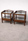 A pair of mahogany nightstands featuring a galleried top with an inset shaped mirror plate,