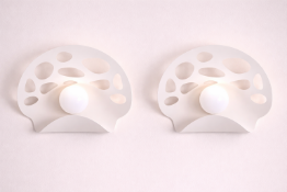 Pair of I-Lite Perforated Shell Wall Sconce This I-Lite Wall Lamp features a modern, organic