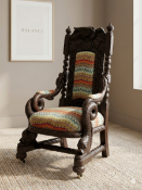 An exceptional Victorian‑style carved oak throne chair is a dramatic fusion of Gothic and
