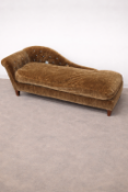 A Victorian style chaise longue upholstered in a rich, olive-brown velvet fabric, featuring a