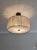 A modern 3-light flush mount ceiling fixture featuring a translucent fabric drum shade with a