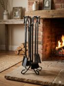 A contemporary wrought iron fire companion set finished in a matt black coating, comprising a