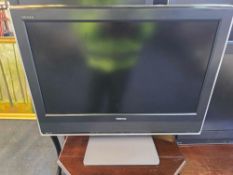 A 26-inch Toshiba 26WLT66S LCD television in a classic mid-2000s style, featuring a matte black