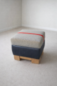 A contemporary square ottoman footstool or dressing seat from the bespoke British manufacturer