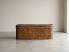 A grand contemporary woven rattan ottoman storage chest / blanket box of elongated rectangular form.