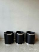 A set of three matching bedroom or office waste bins. Each cylindrical bin features a textured black