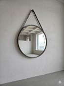 A stylish contemporary circular wall mirror of modern Scandinavian design, measuring 70cm in