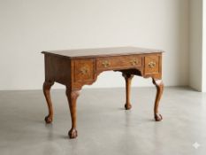 This is a fine Georgian style lowboy table crafted in burr walnut with cabriole legs.A