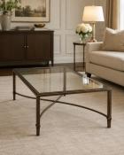 A Contemporary Bronzed Metal and Glass-Topped Coffee Table The table features a substantial