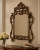 A Mid-20th Century Chippendale Style Carved Giltwood Wall Mirror The mirror features an arched