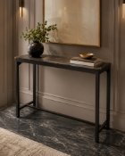 Faux-Marble Console Table A sleek, modern console table designed with a clean, industrial