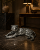 Resin Tiger Sculpture A large-scale ornamental sculpture of a tiger in a resting, recumbent pose,