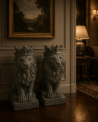 A Pair of Cast Resin Seated Crowned Lion Sculptures Each figure is cast in heavy structural resin,