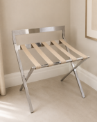 Mertnk folding luggage rack constructed from polished stainless steel, featuring a sturdy X-frame