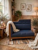 A commercial-grade banqueting bench seat upholstered in deep blue leather, built into a brown timber