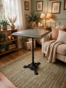 A modern commercial poser bar table featuring a thick square grey wooden top, securely mounted on