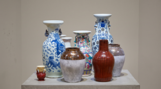 A diverse collection of nine decorative vases showcasing a blend of traditional Chinese and Japanese