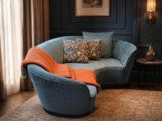 A contemporary teal blue crescent-shaped curved sofa, expertly upholstered in premium velvet from