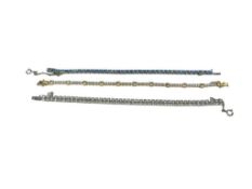 THREE ELEGANT LADIES TENNIS BRACELETS INCLUDING ONE SIGNED KRAMER