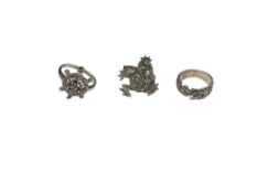 THREE STERLING SILVER MARCASITE RINGS INCLUDING A FIGURAL FROG AND TURTLE DESIGN WITH RED STONES