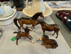 FOUR BESWICK ENGLISH POTTERY HAND PAINTED PORCELAIN GLOSSY BROWN FOAL AND COLT HORSE FIGURES