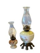 TWO ANTIQUE MILK GLASS OIL LAMPS WITH FLORAL DESIGN