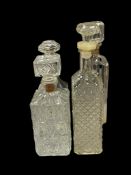FOUR VINTAGE GLASS DECANTERS TWO ARE EMBOSSED LAW FORBIDS SALE OR RE-USE OF THIS BOTTLE