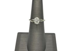 14K WHITE GOLD DIAMOND SOLITAIRE RING FEATURING AN OVAL CUT DIAMOND