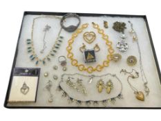 ASSORTED LADIES COSTUME JEWELRY INCLUDING HEART NECKLACES, GOLD TONE DESIGNS, AND CLIP BACK EARRI...