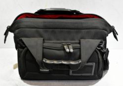 Canon EOS C100 camera with handle attachment, charger, 3 x batteries, Sachtler bag