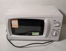 Box containing 12x standard home or workplace use microwaves, brands including Igenix and Currys