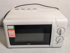 Box containing 12x standard home or workplace use microwaves, brands including Igenix and Currys