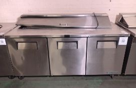 True TSSU-72-18-HC stainless steel 3 door refrigerator and food preparation area